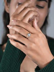 A woman's elegant finger ring with a white diamond