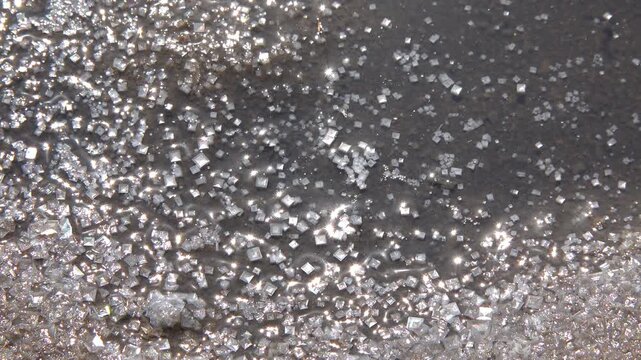 Kuialnyk Estuary, square crystals of salt Sodium chloride in a puddle on the shore of a drying reservoir