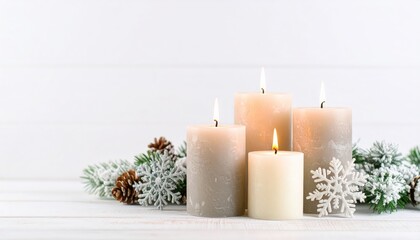 Four lit cream candles with frosted pine branches, pine cones and decorative snowflakes arranged as a cozy winter holiday centerpiece.