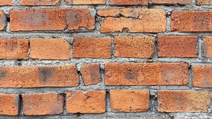 Obraz premium red brick wall close up with aged texture and visible mortar lines