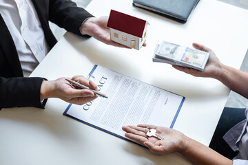 Estate agent sending house model to client after signing agreement contract real estate with...