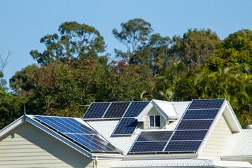 Solar panels on angular house roof with attic window