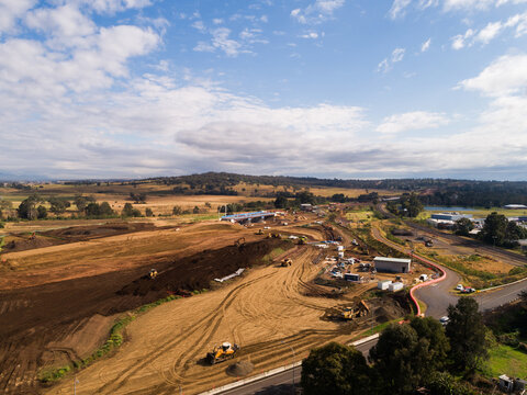 Aerial of construction site with earthworks and machinery on worksite building singleton bypass