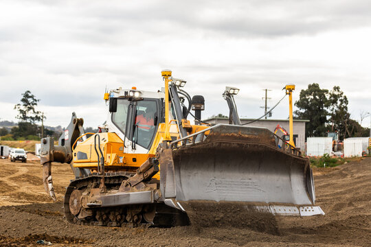 Bulldozer pushing dirt around construction worksite