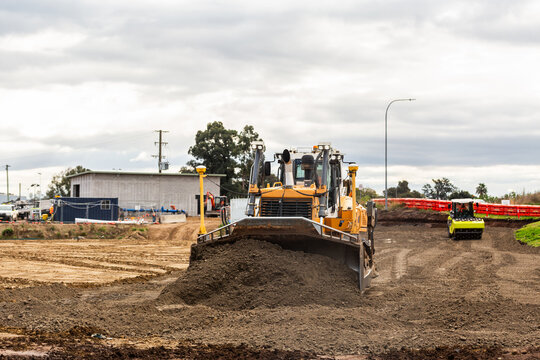 Bulldozer on worksite pushing soil around during Singleton Bypass infrastructure construction