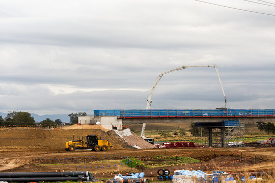 Grader and cement machine working on construction of Singleton Bypass in the Hunter Valley