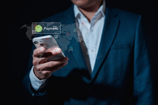 Businessman using smartphone with digital payment icon and global network map, concept of mobile banking, fintech, secure online transaction, e-commerce and international money transfer.