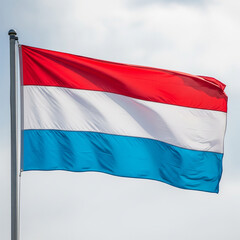 Fototapeta premium Luxembourg flag waving in the wind against a bright sky.