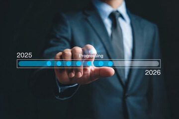 Dark blue photo shows a man progressing from 2025 to 2026. Use for futuristic progress, business planning, timeline graphic, or digital interface background.