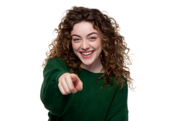 Cheerful young woman with curly hair in green pointing at viewer