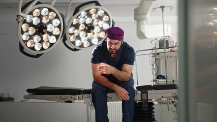 A tired surgeon sits on an operating table in a modern operating room, expressing stress or exhaustion after a long operation. A concerned doctor in a surgical setting
