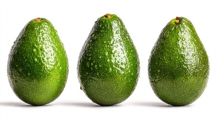 Three ripe avocados, glistening with water droplets, arranged in a horizontal row against a white background