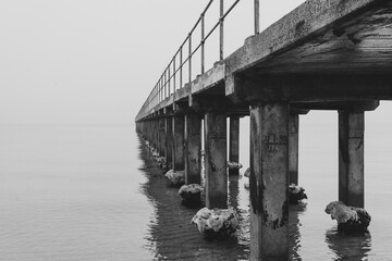 A Long Pier on a Calm, Misty Day in Black and White