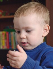 Baby looking intently at a phone