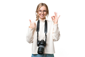 Young photographer English woman over isolated background showing ok sign and thumb up gesture