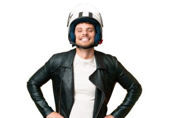 Brazilian man with a motorcycle helmet over isolated chroma key background posing with arms at hip and smiling