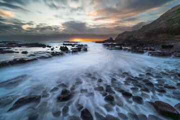Coastal Inlet at Sunset with Long Exposure Water