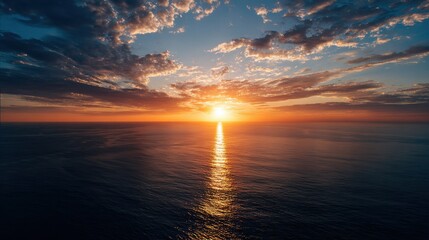 Stunning sunset over a calm body of water with vibrant orange and pink hues illuminating the sky and reflecting on the