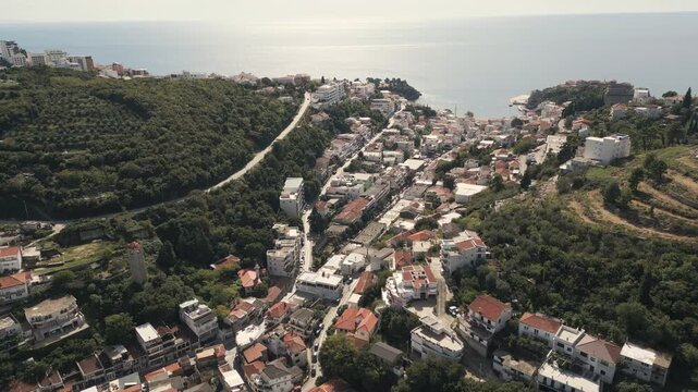 Ascending aerial capture unveils a scenic panorama of Ulcinj, a coastal town nestled on the Adriatic shore in the south of Montenegro.
