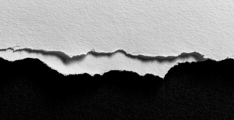 Torn white paper edge against black backdrop