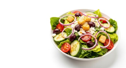 A white bowl contains a salad with lettuce tomatoes onions cucumbers croutons olives  feta cheese