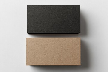 Two blank business cards, black and kraft, lie flat
