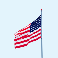 American flag waving against a pale blue sky usa flag