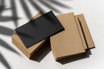 Business cards, black and kraft, in shadow