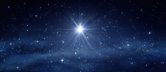 Fototapeta premium A brilliant star shines brightly in a dark night sky, dotted with countless smaller stars. A celestial glow emanates outward from the central star