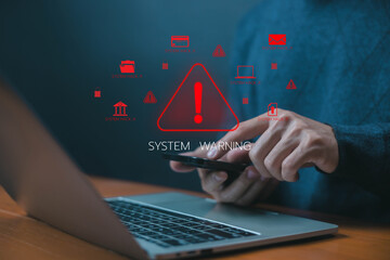 Cybersecurity warning concept. hacker alert icon on laptop and smartphone, symbolizing system hack, malware attack, phishing risk, and online data security threat prevention. system warning error