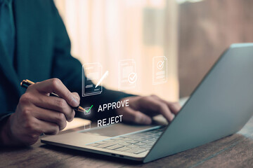 Businessman approving document on digital platform using laptop, concept for online contract, e-signature, workflow automation, and paperless office in modern business management. approving online