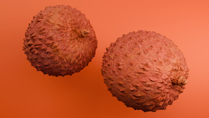 Two lychee fruits on orange background close-up