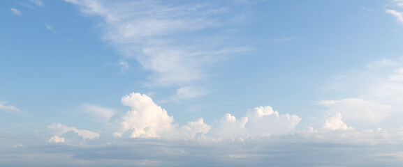 SSky replacement of light blue sky and puffy and wispy white and gray clouds far in the horizon over a large body of water