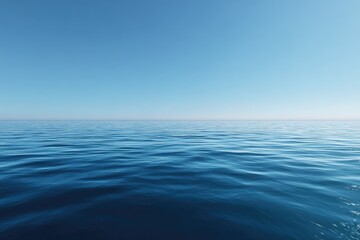 Wide shot of a calm, deep blue ocean meeting a clear, bright blue sky