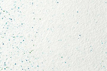 Obraz premium Textured white background with scattered small, colorful dots