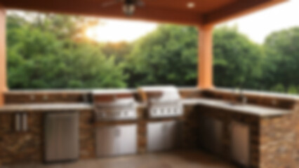 Obraz premium Blurred image of outdoor kitchen interior with open nature theme, kitchen equipment visible, Evergreen, blurry wallpaper.