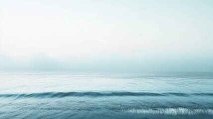 A serene seascape with gentle waves and a soft, misty atmosphere, evoking calmness and tranquility.