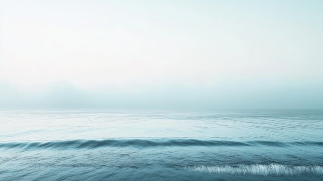 A serene seascape with gentle waves and a soft, misty atmosphere, evoking calmness and tranquility.