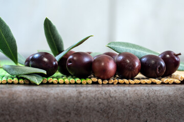 A bountiful harvest of ripe black olives is elegantly displayed. This photo captures the essence of the Mediterranean diet, rich in healthy fats, antioxidants, and traditional flavors.

