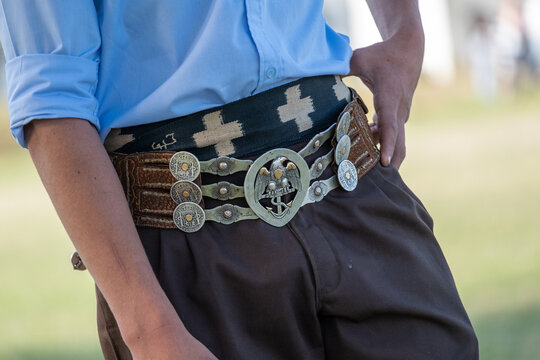 A close-up shot of a man's traditional Gaucho belt (rastra) with intricate details and classic design. A powerful symbol of Argentine culture