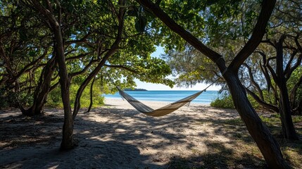 A serene beach scene featuring a hammock nestled among trees, inviting relaxation by the shore with a view of the ocean in the background.
