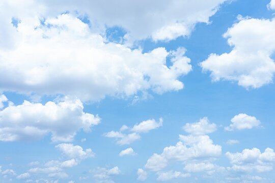 Bright blue sky with fluffy white cumulus clouds A scenic daytime view of scattered clouds