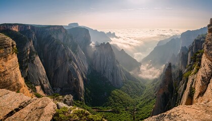 Fototapeta premium a rugged mountaintop with sheer cliffs dropping into a misty canyon below