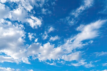 Vast, vibrant blue sky dotted with fluffy white clouds