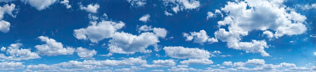 Obraz premium Wide shot of a partly cloudy, vibrant blue sky (1)