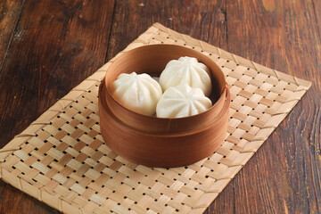 Bakpao Coklat, chinese steamed buns with chocolate paste on bamboo basket
