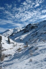 Snowy mountain valley under a vibrant blue sky