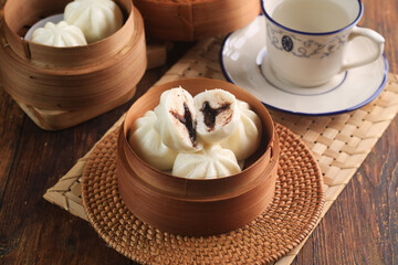 Bakpao Coklat, chinese steamed buns with chocolate paste on bamboo basket
