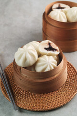 Bakpao Coklat, chinese steamed buns with chocolate paste on bamboo basket
