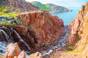 Battery waterfall on the shore of the Barents Sea. Teriberka, Kola Peninsula, Russia. © lizavetta